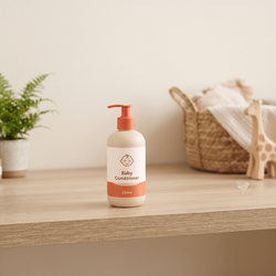 Baby Conditioner 250ml cream white pump bottle with terracotta orange pump and baby face icon on wooden shelf