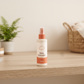 Baby Detangler 150ml white spray bottle with terracotta orange nozzle and cloud icon on wooden shelf